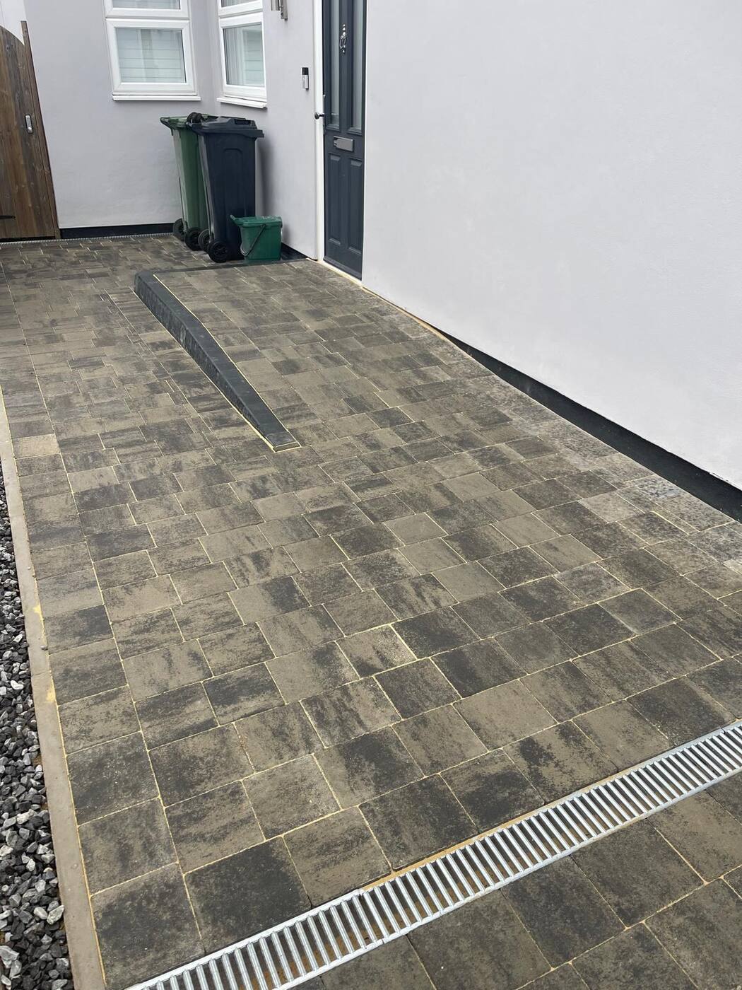 Channel drain and kerb detail on a block paving driveway