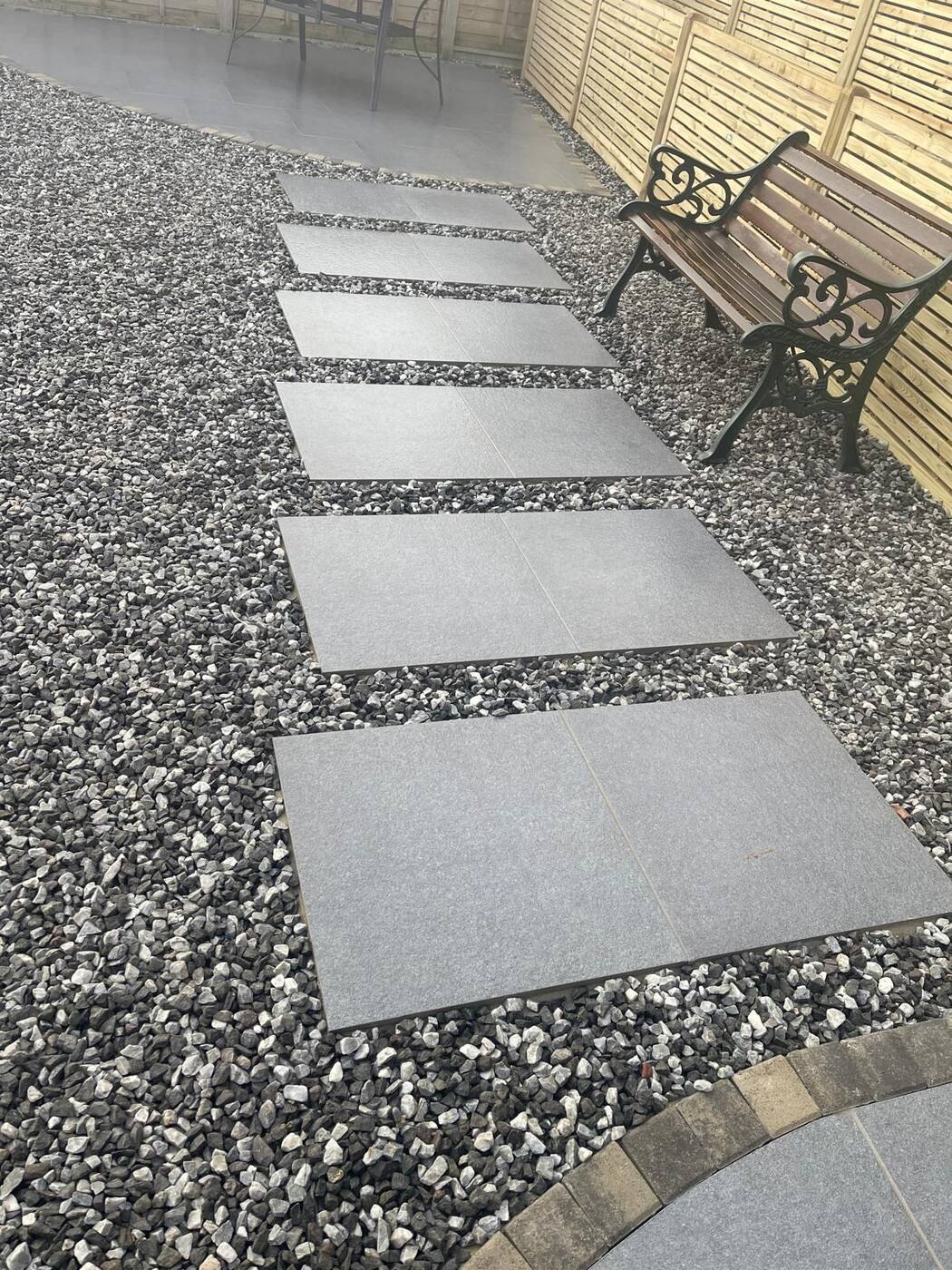 Porcelain stepping stone path through gravel garden